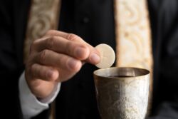 close up hand holding eucharist